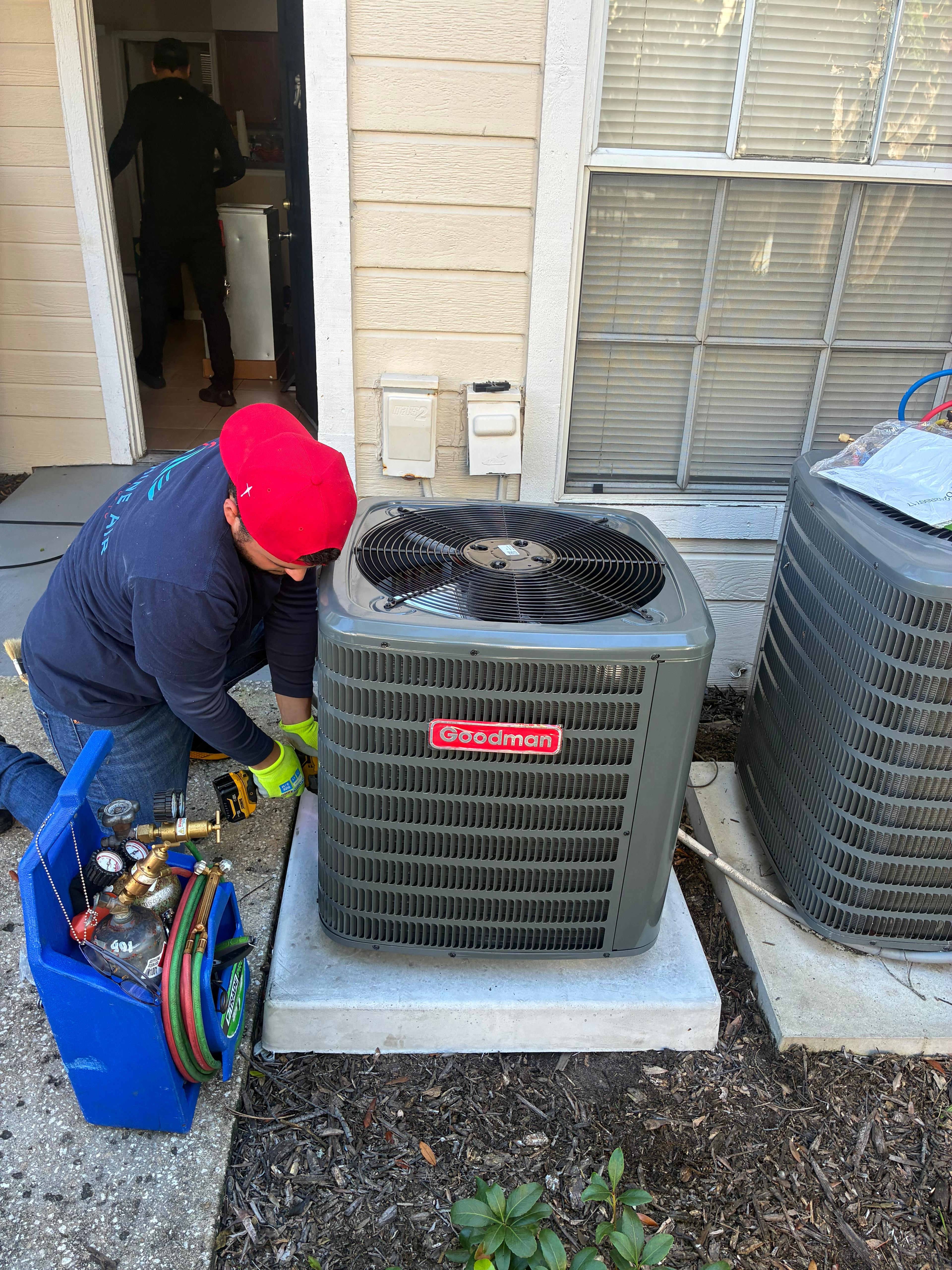 Sunshine Air HVAC technician working on an AC system